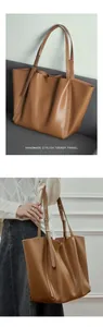 Macro view of brown leather texture and adjustable shoulder strap detail on tote bag