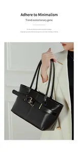 Close-up of black leather tote bag featuring gold buckle details and minimalist design
