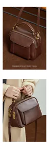 Détails du sac à main en cuir tanné avec plusieurs zips et bandoulière réglable