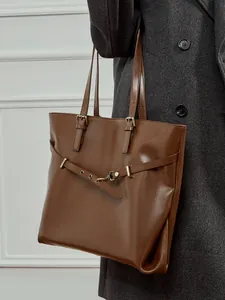 Brown vegetable tanned leather tote bag with vintage metal buckle and adjustable shoulder strap