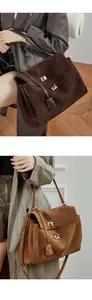 Detail of silver twist lock on dark brown and caramel suede tote bags with leather straps