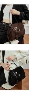 Close-up of matte leather tote bag with metallic turn-lock and adjustable shoulder strap