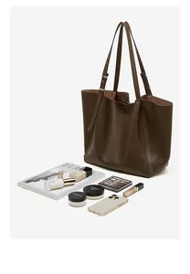 Spacious dark brown tote bag interior filled with daily essentials for commuting