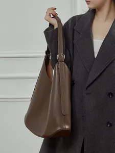 Minimalist dark brown leather shoulder bag for women with silver hardware details