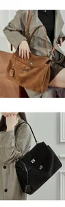 Detailed view of large suede leather tote bags with metal turn-lock closure for commuting