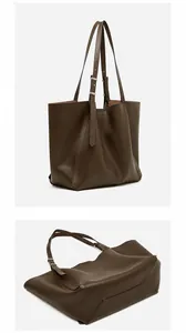 Detail view of the 45 degree back and bottom structure of coffee brown leather tote bag