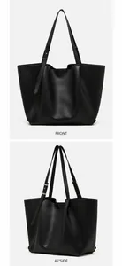 Detail view of large black tote bag featuring premium leather texture and adjustable strap