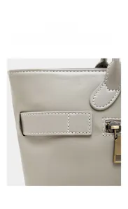 Detailed macro view of gray leather texture with neat stitching and bronze metal zipper
