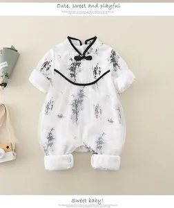 Detail of baby romper featuring Chinese ink bamboo print and traditional frog buttons
