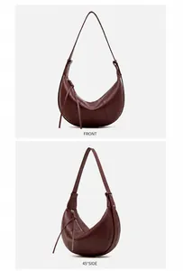 Macro detail of wine red pebbled leather croissant bag showing texture and zippers