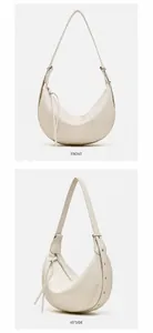 Detail view of pearl white hobo bag showing litchi leather texture and fringe zipper