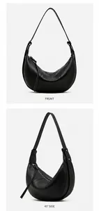 Detail of black pebbled leather croissant bag showing front and side view with zippers