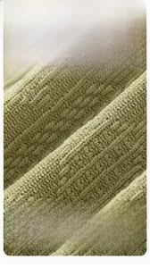 Detailed macro view of soft combed cotton honeycomb fabric for newborn rompers