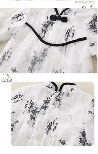Detail of Chinese ink bamboo print and traditional frog button on baby girl romper