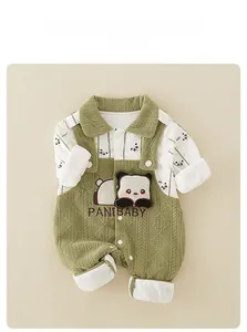 Detailed flat lay of green knitted newborn romper with a cute panda patch and embroidery