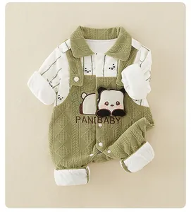 Detailed macro view of green quilted texture and 3D panda patch on newborn romper