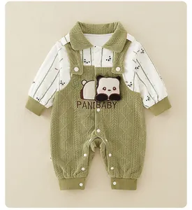 Close-up of baby romper showing panda embroidery and quilted textured green fabric
