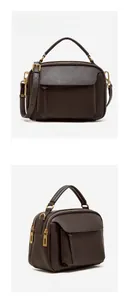 Détail macro du sac à main en cuir chocolat avec ferrures dorées et double compartiment zippé