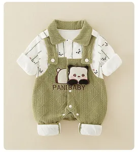 Close-up of baby panda romper with green corduroy texture and panda embroidery