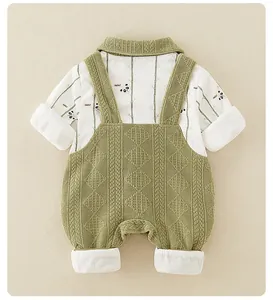 Close-up of knit texture on newborn romper with panda print and green overalls