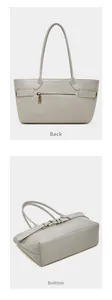Detail view of the back zipper pocket and wide bottom of this light gray leather tote bag