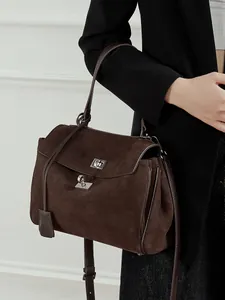 Classic dark brown matte suede tote bag with metallic lock shown in a 45-degree side view