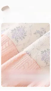 Detail of baby floral knit fabric showing soft breathable texture and pink ribbed lining