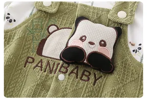 Detail of baby romper featuring a 3D plush panda, embroidery, and soft green knit fabric