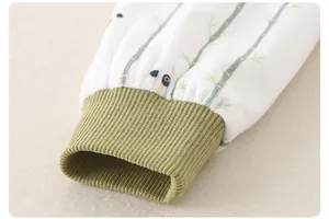 Detail of ribbed cuffs on newborn jumpsuit with cute panda and bamboo pattern