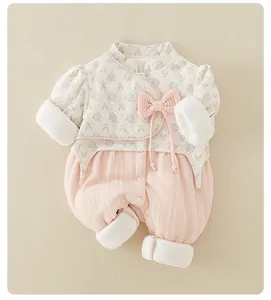 Detail of infant floral romper with Chinese collar, pink bow, and pearl decoration