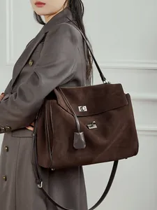 Large dark brown suede tote bag with silver buckles and spacious interior for commuting