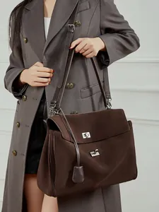 Large dark brown suede tote bag with adjustable strap and silver turn-lock closure