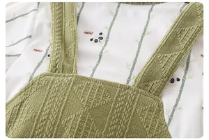 Detail of newborn baby knit romper showing bamboo panda print and diamond weave texture