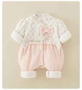 Detail of pink floral baby romper with Chinese retro style bow and quilted cotton fabric