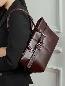 Elegant burgundy leather tote bag with stylish belt buckle detail for professional women