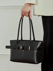 Minimalist black leather tote bag with gold buckle belt detail for office commute