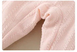 Close-up of pink baby trousers showing delicate knit texture and durable crotch seams