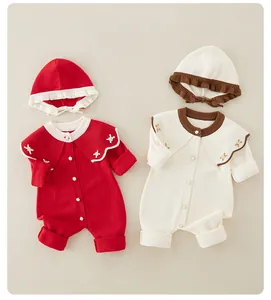 Detail von gestrickten Baby-Stramplern mit Stickerei und passenden Mützen für Neugeborene