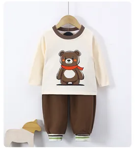 Close-up of baby long-sleeved set featuring a cute cartoon bear and striped ribbed cuffs