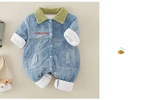 Close-up of baby denim romper featuring green corduroy collar and button closure
