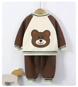 Detail of baby boys tracksuit with contrast panels and brown bear print on back