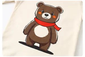 Detail shot of a beige cotton T-shirt featuring a cute cartoon bear print with a red scarf