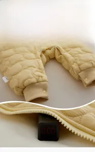 Macro detail of quilted baby romper featuring cloud patterns and safety test sensor