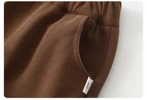 Detail of coffee brown knitted pants featuring elastic waist and side pocket for toddlers