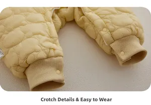 Detail of baby quilted romper featuring bear patterns and snap buttons at the crotch