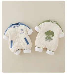 Detail of quilted cotton baby rompers with penguin and dinosaur embroidery for winter