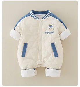 Detailed view of quilted cotton baby romper with penguin embroidery and blue contrast trim