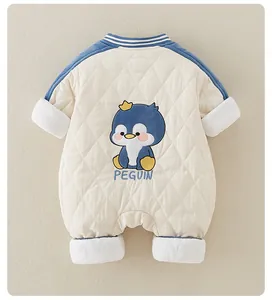 Detail of baby winter romper featuring diamond quilting and cartoon penguin embroidery