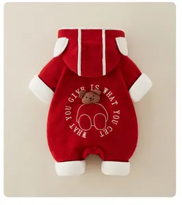 Detail of red fleece baby romper featuring 3D plush bear head and white hood ears