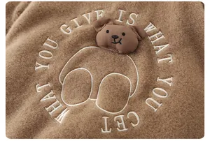 Detail of 3D bear embroidery on thick brown fleece infant winter romper garment